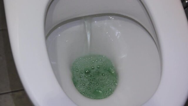 flushing water in the toilet close-up.