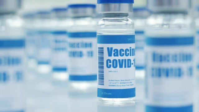Lot of Covid 19 coronavirus vaccine vials bottles for injections on medical pharmaceutical industry table. Corona virus cure manufacture, flu treatment drug pharmacy production concept, close up view