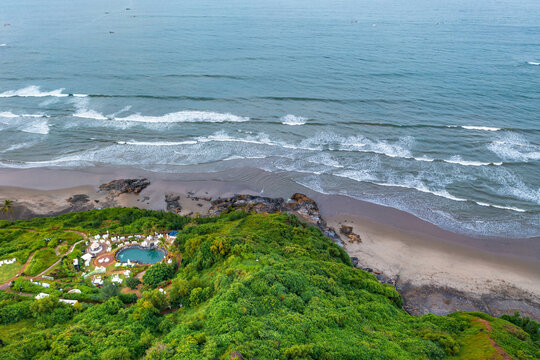 Aerial view of resort with pool on the coast of Goa, India.