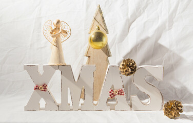 Christmas background with wooden letters, pine cone and ball