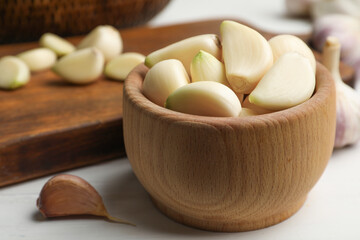 Fresh organic garlic on white table, closeup