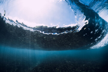 Breaking wave with foam and bubbles underwater. Transparent water