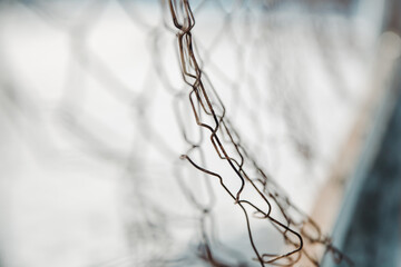 chain link fence. wire mesh fence with snow on blurred background
