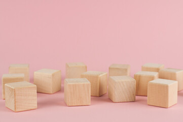 Wooden cubes on a pink background. Place for text