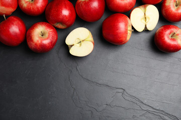 Fresh ripe red apples on black table, flat lay. Space for text