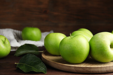 Fresh ripe green apples on wooden table, closeup