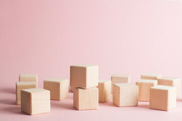 Wooden cubes on a pink background. Place for text