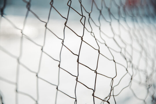 chain link fence. wire mesh fence with snow on blurred background