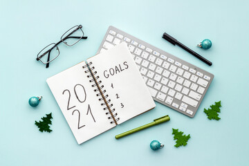 Inspiration concept - New Years goals written in notebook on a table, flat lay
