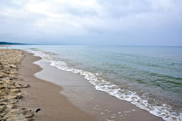 Fototapeta na wymiar Sandy deserted seashore. Cold deserted beach