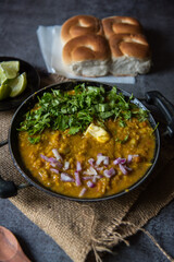 Close up of Indian snacks pav bhaji or bread masala curry in a black pan 