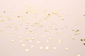 Confetti stars on pink background. Christmas celebration
