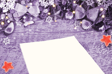 Christmas, purple background with bokeh and red stars. A blank sheet of paper for text
