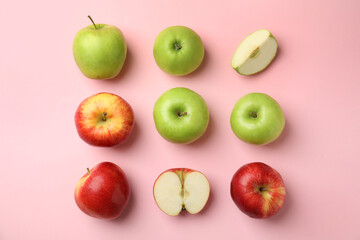Many different ripe apples on pink background, flat lay