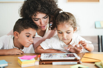 Mother doing home schooling with little children - Technology and digital tablet - Lockdown and...