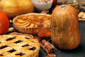 Tart pie and pumpkin on dark black surface