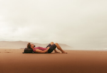 Fototapeta na wymiar Lonely guy on red sand beach