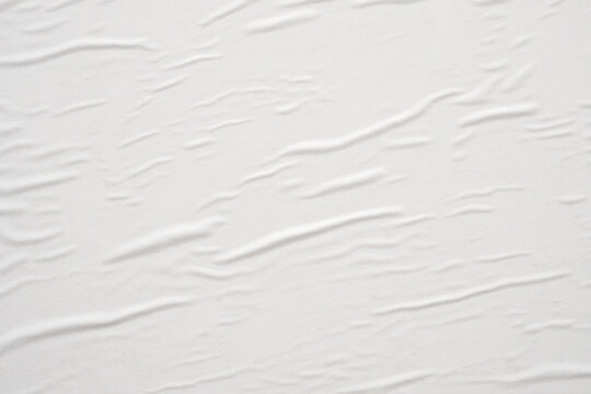 Blank white crumpled and creased paper poster texture background © Piman Khrutmuang