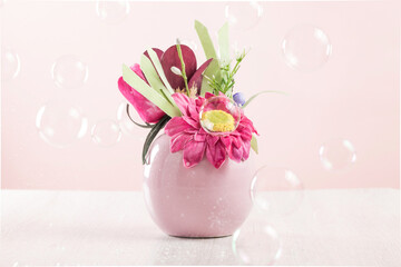 There are many soap bubbles floating around the vase