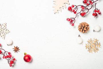 Christmas composition with red and white decorations and wooden toys at white marble background. Flat lay image with copy space.