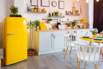 Trendy fashion luxury interior design in Scandinavian style of studio apartment with bright yellow furniture and decorated with new year lights.