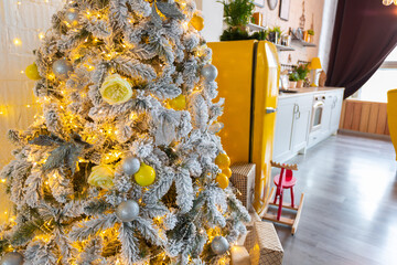 Trendy fashion luxury interior design in Scandinavian style of studio apartment with bright yellow furniture and decorated with new year lights.