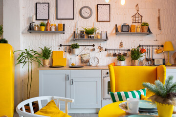 Trendy fashion luxury interior design in Scandinavian style of studio apartment with bright yellow furniture and decorated with new year lights.