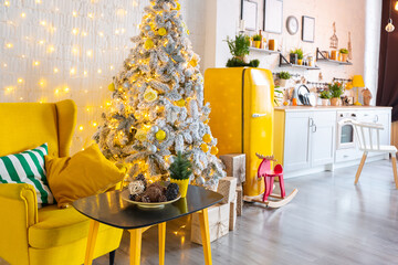 Trendy fashion luxury interior design in Scandinavian style of studio apartment with bright yellow furniture and decorated with new year lights.