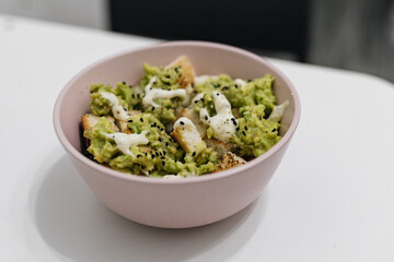 Healthy salad with tuna, guacamole, bread and sesame sauce 