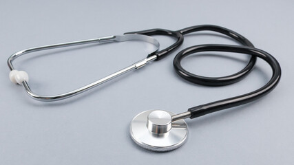close up of stethoscope.

Stethoscope on a gray background, close-up side view.