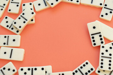 Pieces of dominoes framing an orange copy space in the center of the image