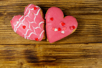 Fototapeta na wymiar Heart shaped cookies on wooden table. Top view, copy space. Dessert for valentine day
