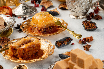 Piece of Turkish baklava in golden arabic plate