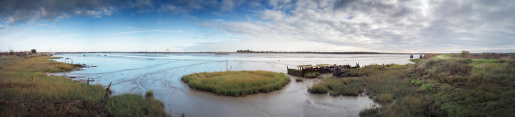 panoramic landscape image of mudflat in essex england