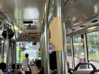 a bell in a crowded bus in Singapore during the day