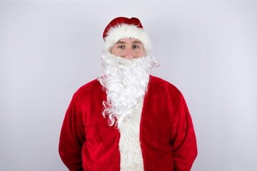 Fototapeta na wymiar Man dressed as Santa Claus standing over isolated white background looking at the camera, smiling confident.