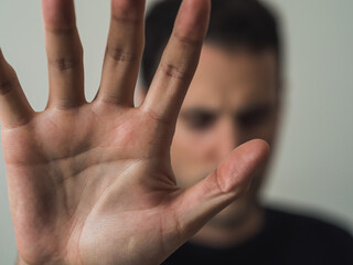 An angry man with the hand. Sign stop. Copy space