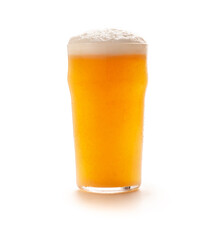 Full cold glass goblet of light craft ale with foam and flowing drops