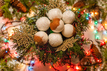 Christmas decoration with christmas tree balls, pine branches and christmas lights