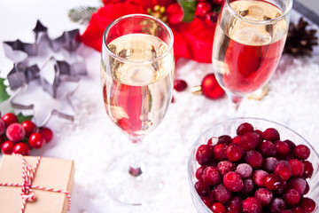 Champagne glasses with cranberry and Christmas decoration. Christmas and New Year concept.