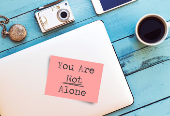 pink post it paper with You Are Not Alone concept