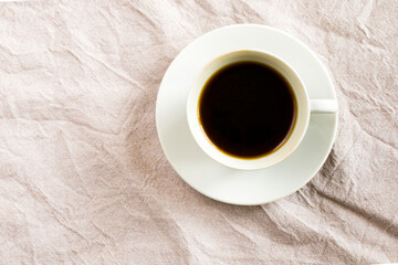 Cup of black espresso coffee on the white cloth background, morning drink