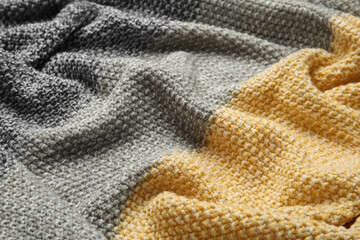Soft crumpled knitted plaid as background, closeup