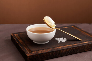 Traditional Tibetan butter tea or churned tea in white bowl. Asian drink known as 