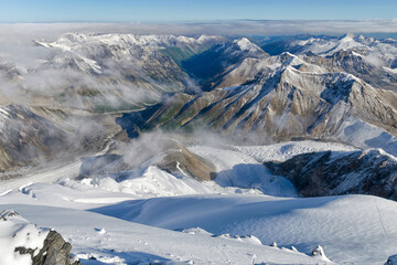 Above the mountains and clouds. View from the slope of Marble Wall Peak, Central Tian Shan, Kazakhstan - China.
