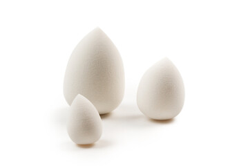 Small, medium and large  white beauty blender isolated.