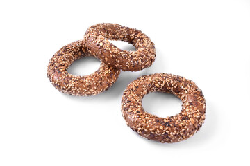 Three sesame seed bagels isolated on white background