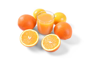 Orange juice in glass with oranges and lemon on white background