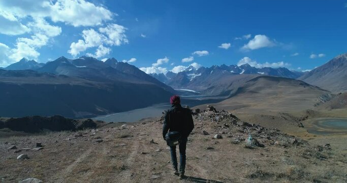 Earth Aerial: Solo Backpacker exploring a majestic mountain landscape. Unexplored and wild places of Himalayan National park. Spiti, Himachal Pradesh, India