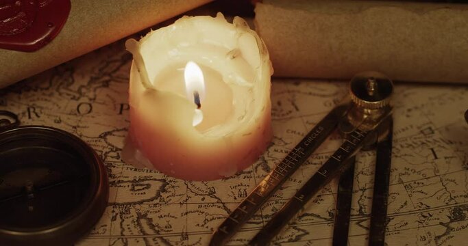 Ancient map of the XVII century with compass and candle